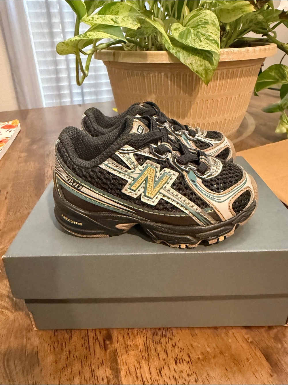 New Balance Kids Black, Teal, and Cream Athletic Sneakers